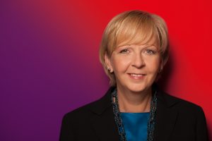 Portrait von Hannelore Kraft vor rot-purpurnem Farbverlauf