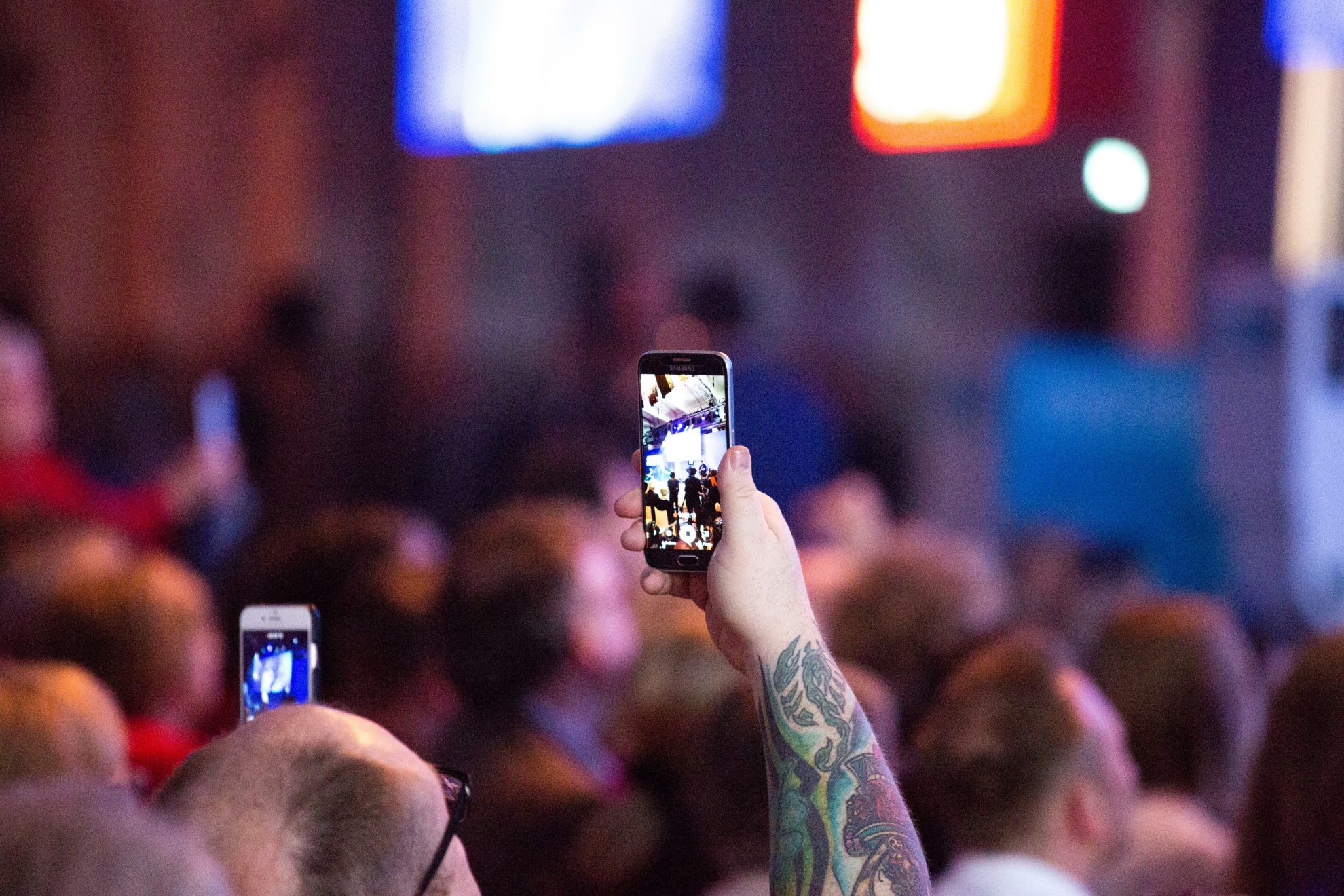 Ein Mann fotografiert mit einem Handy den Wahlkampfauftakt